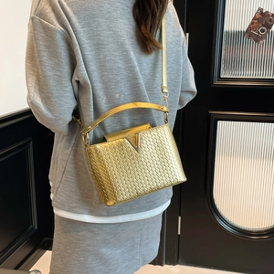Fashionable golden woven crossbody bag with metallic V-shaped buckle and chain strap