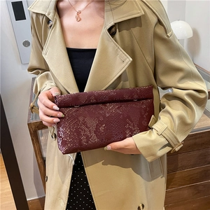 Deep red snake-patterned envelope clutch bag with premium faux leather texture