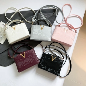 Minimalist V-shaped textured handbags in five colors with top handles and shoulder straps