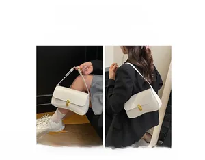 Detail showing white PU leather small square bag with gold metal clasp and versatile strap