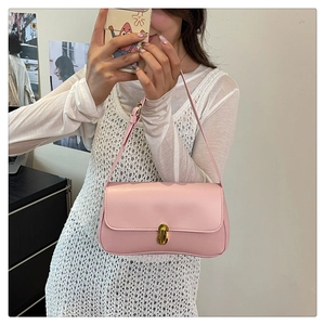 Detailed shot of pink PU leather underarm bag featuring a gold oval twist lock closure