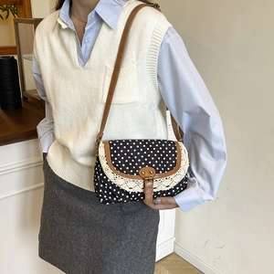 Retro canvas crossbody bag with white polka dots, lace trim, and brown leather strap
