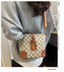 Detail of vintage monogram bucket bag with adjustable leather strap on model
