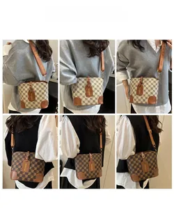 Detail view of vintage checkerboard bucket bags in dark brown and beige with wide straps