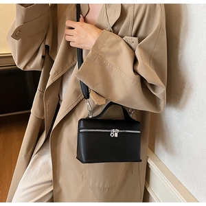Classic black litchi pattern leather vanity bag with silver zippers shown on model