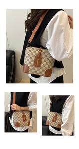 Detail of vintage bucket bag with beige monogram fabric and brown leather trim accents