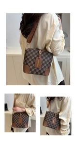 Detail view of the brown checkered bucket bag with branded strap and leather tag