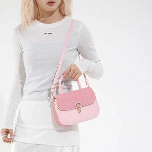 Pink patchwork leather saddle bag with woven texture flap and golden horseshoe buckle