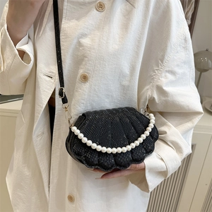 Sac bandoulière noir minimaliste avec texture serpent et poignée en perles blanches