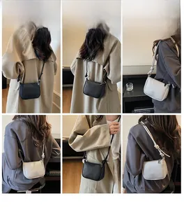 Litchi pattern square bag with zipper closure and decorative knot strap detail