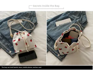 Macro detail of drawstring bucket bag with strawberry prints showing inner main pocket