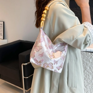 Elegant lavender satin underarm bag with butterfly embroidery and wooden bead strap