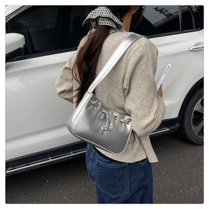 Silver metallic square shoulder bag featuring drawstring detail and sleek PU leather texture