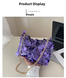 Detail of purple sequin shoulder bag featuring shiny round scales and a gold chain strap