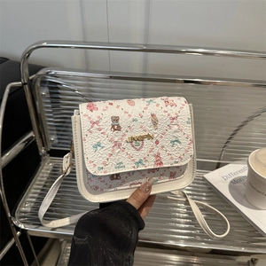 Cute white square bag with floral cartoon prints and thin strap, handheld display