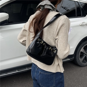 Stylish black PU leather square underarm bag with gold metal eyelets and drawstring bows