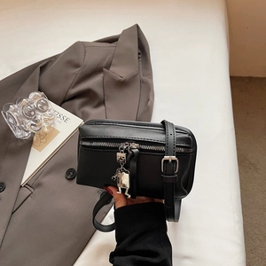 Minimalist black leather square bag with robot charm and silver buckle detail for women