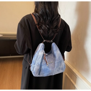 Blue retro texture backpack shown from a back view with adjustable brown leather straps