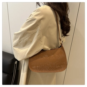 Close-up of a brown snakeskin pattern hobo bag worn by a model for daily styling