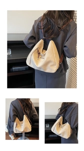 Detail view of large beige hobo bag with Fashion logo and brown shoulder strap