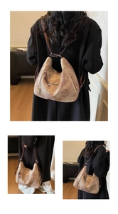 Detail of vintage brown suede tote bag featuring silver Fashion logo and dual straps