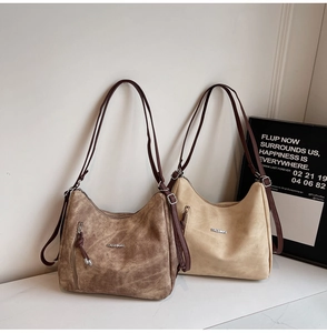 Detailed close-up of retro hobo bags in dark brown and beige with polished fashion logo