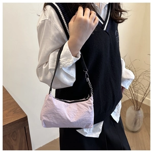 Detailed close-up of light purple nylon moon bag with chain and black shoulder strap