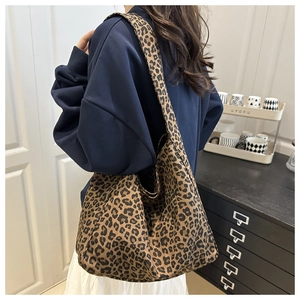 Detail shot of the large leopard print tote bag fabric and wide shoulder strap