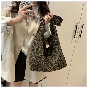 Close-up of leopard print canvas tote bag showing soft texture and large capacity