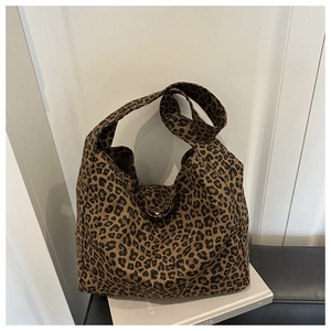 Close-up of leopard print canvas tote bag with thick texture on white lifestyle background