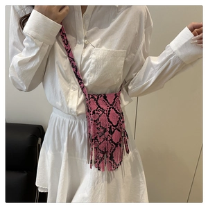 Detail view of pink snake print mini crossbody bag with long stylish fringe accents