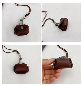 Detailansicht der dunkelbraunen Mini-Leder-Kopfhörertasche mit Druckknopf und Umhängeband