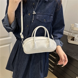 Glossy white minimalist baguette bag with top handle and adjustable shoulder strap