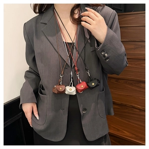 Close-up of mini leather earphone pouches in four colors with snaps and long neck lanyards