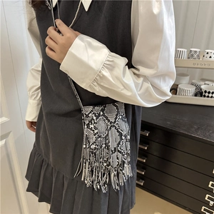 Chic snakeskin print mini crossbody bag featuring long bohemian tassels and leather strap