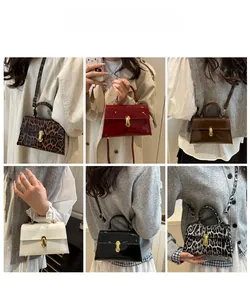 Detailed view of fashionable crossbody bags in leopard print, red, and solid colors