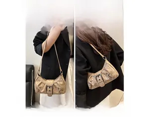 Detail of vintage champagne underarm bag featuring bronze buckle and pleated texture surface