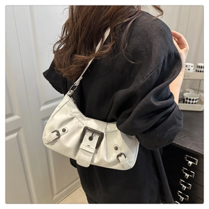 Detail of white glossy underarm bag with vintage metal buckle and leather strap