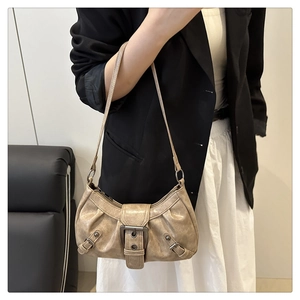 Close-up of vintage distressed leather shoulder bag with metallic buckle detail