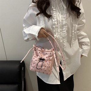 Pink quilted bucket bag with rabbit print and adjustable drawstring for women