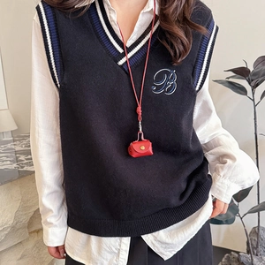 Navy blue V-neck knitted vest with varsity stripes and letter B embroidery on white shirt