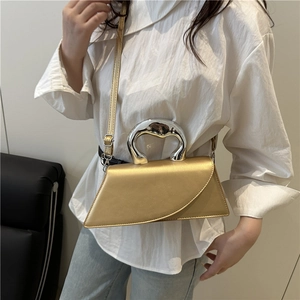 Elegant gold trapezoid handbag with silver metal handle and adjustable crossbody strap