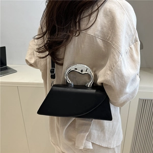 Chic black matte leather handbag with irregular silver metal handle and shoulder strap