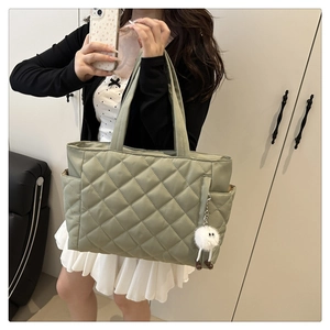 Quilted tote bag in bean green featuring side pocket and cute plush pendant charm