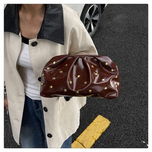 Style de rue d'un sac dumpling plissé marron foncé avec rivets dorés et fini brillant