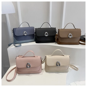 Detailed close-up of colorful women's crossbody bags featuring braided flap texture and metal buckle