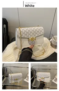 Detail of white chain crossbody bag with M letter print and golden hardware lock