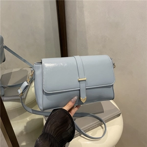 Light blue faux leather crossbody bag with elegant gold heart hardware for women