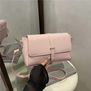 Minimalist light pink rectangular crossbody bag with golden heart clasp and belt detail