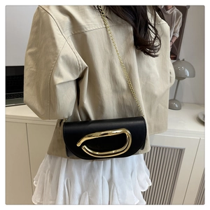 Chic black leather crossbody bag with a distinctive golden metal D logo and chain strap